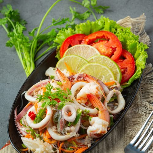 spicy mixed seafood salad with thai food ingredients.